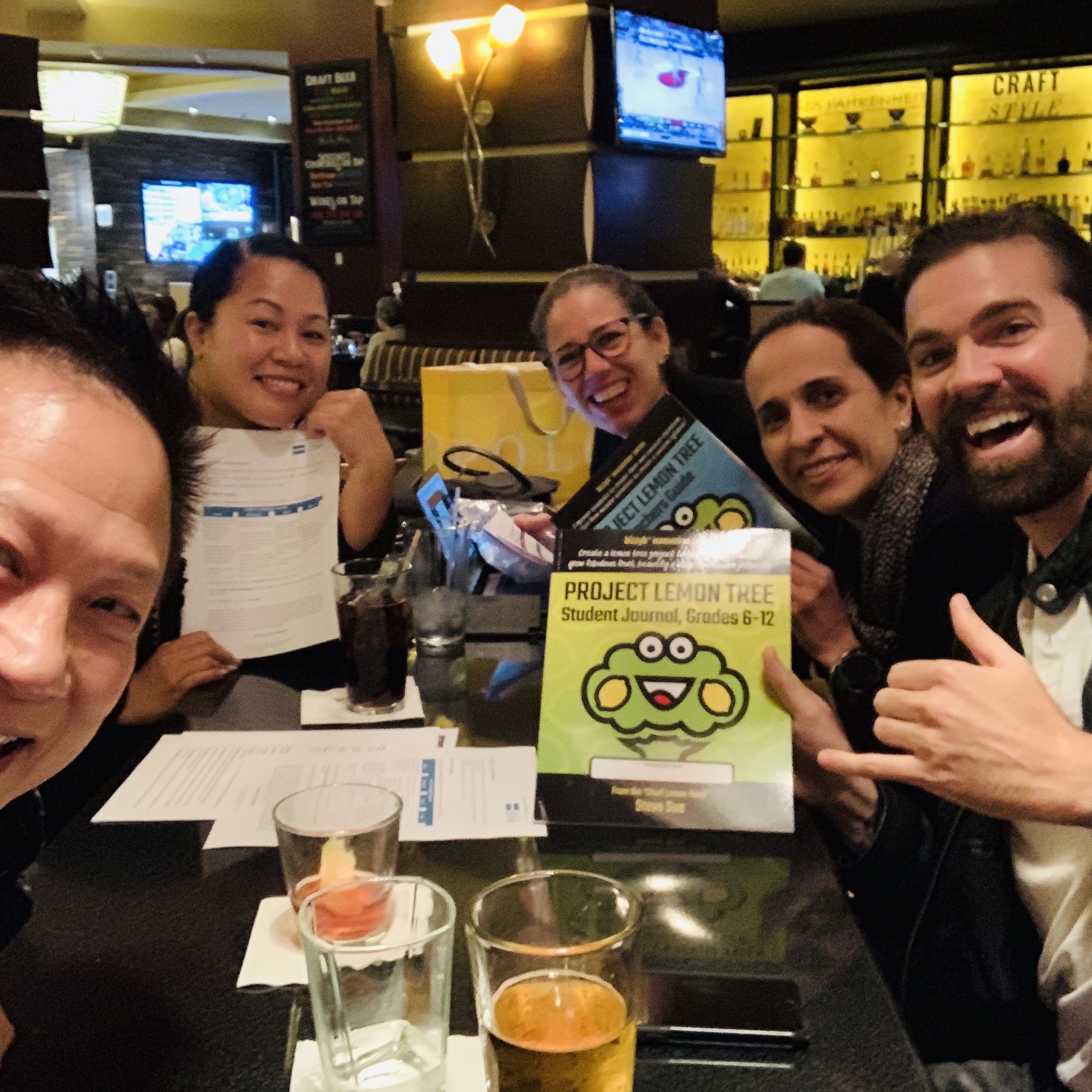 Steve Sue poses at a restaurant with a group from STEM Ecosystems | Bizgenics Foundation